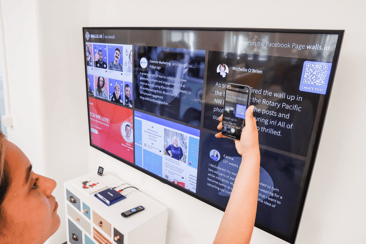 a woman scanning the QR code on the screen